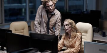 Premium Photo | Young spooky zombie businessman standing next to female  colleague sitting by desk in front of computer monitor during teamwork